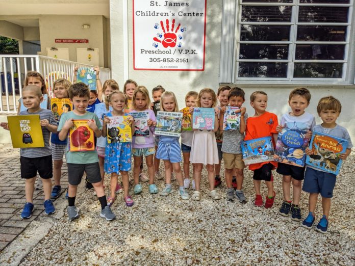 a group of children standing in front of a building