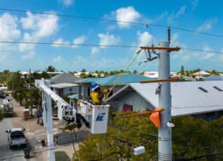 a man on a crane working on a house