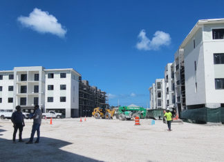 a group of people standing in front of a building under construction