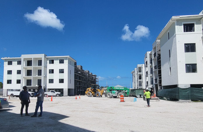 a group of people standing in front of a building under construction
