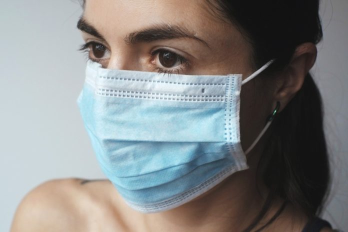 a woman wearing a surgical mask