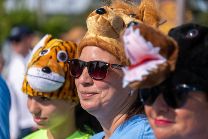 a group of people wearing animal hats