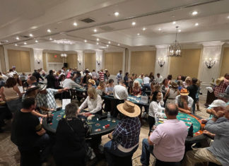 a large room full of people playing cards