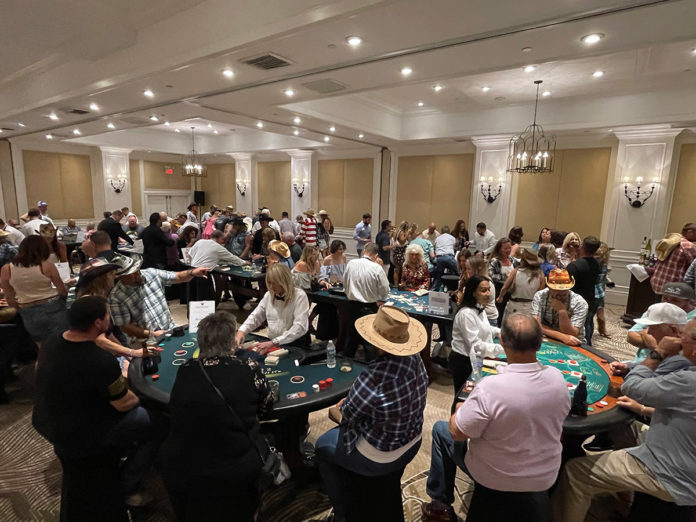 a large room full of people playing cards