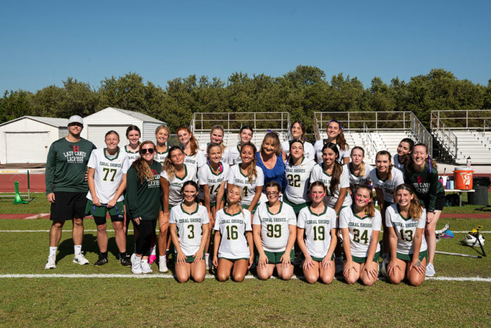 a group of girls soccer players posing for a team photo