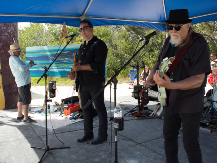 Pasta Painting a group of men standing under a blue tent