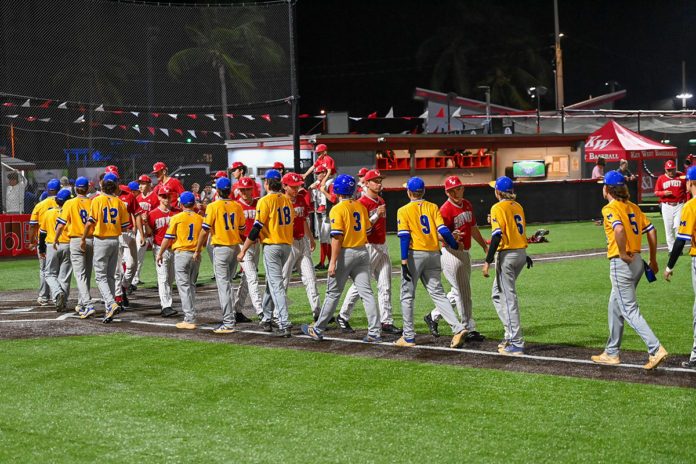 a group of baseball players walking across a field