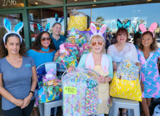 a group of women standing next to each other in front of a store
