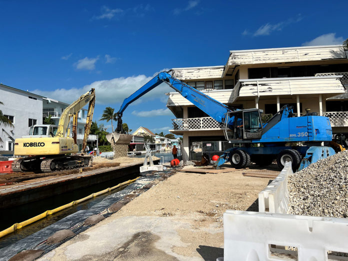 a construction site with a crane and a building in the background