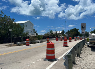 a road with construction cones on the side of it