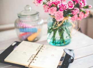 a book and a vase of flowers on a table