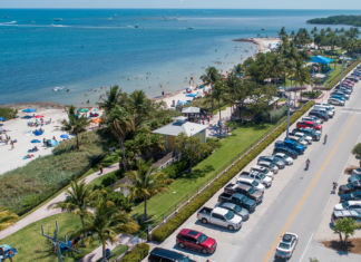 an aerial view of a parking lot next to the beach