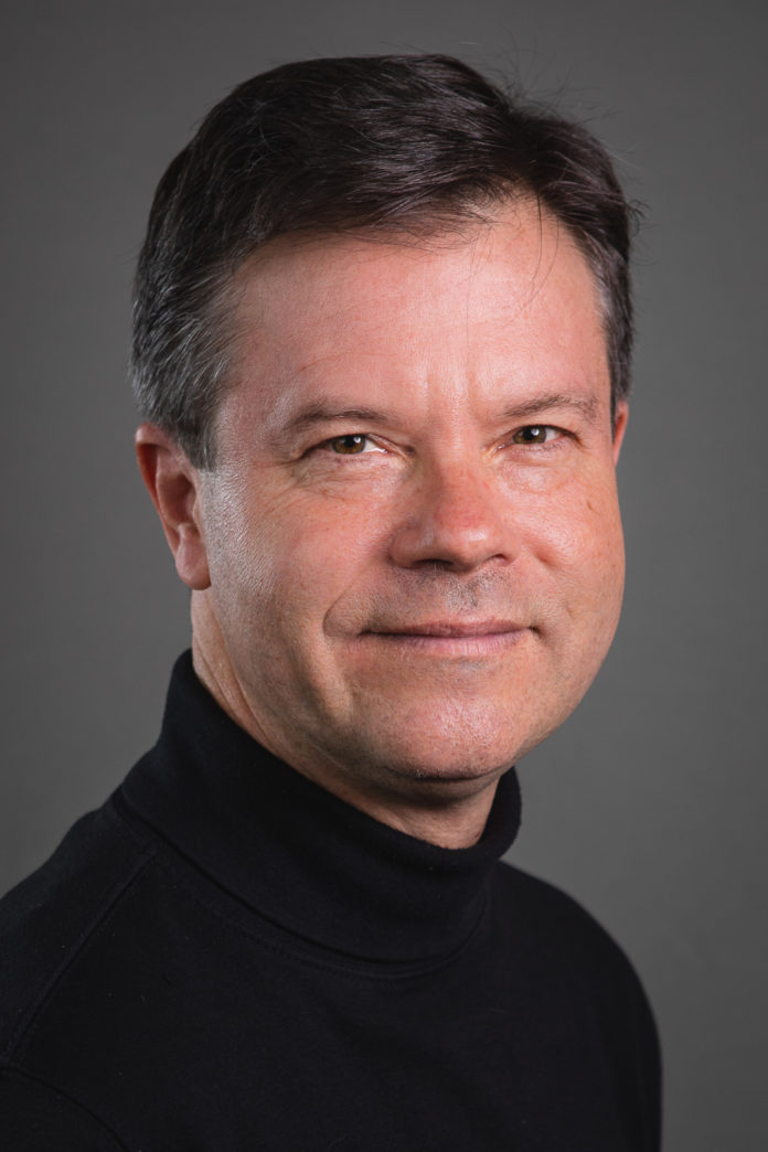 a man in a black turtle neck shirt