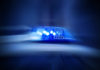 a police car with its lights on in the dark