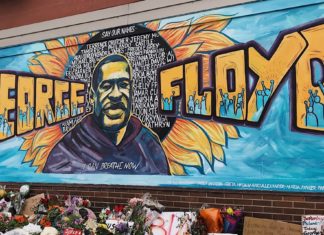 a large painting of a man surrounded by flowers