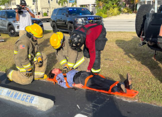 a group of firefighters standing around a man on a stretcher
