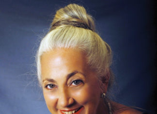 a woman with blonde hair wearing a black top