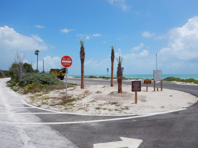 a street with palm trees and a stop sign