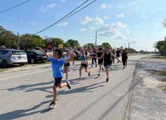 a group of people running down a street