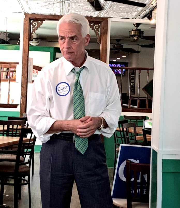 a man in a tie standing in a room