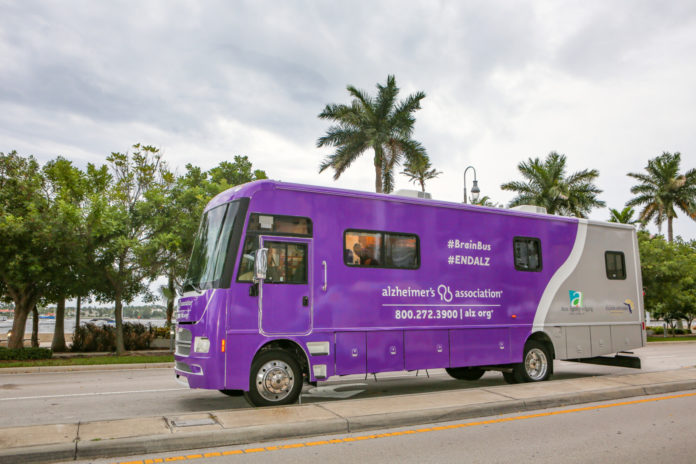 a purple bus parked on the side of the road