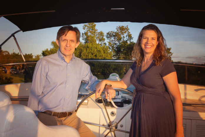 Ilja and husband boat a man and a woman standing on a boat