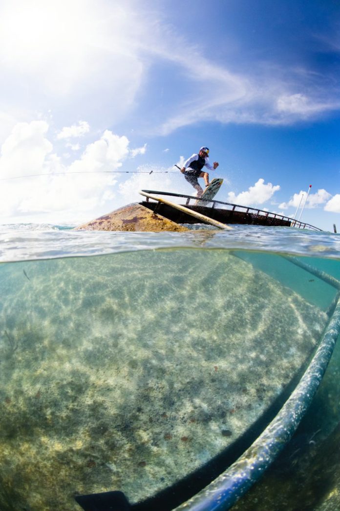 a man riding a surfboard on top of a wave in the ocean