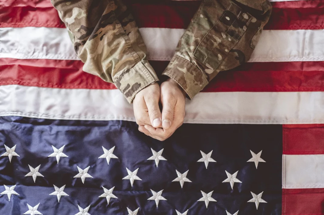 american-soldier-mourning-praying-with-american-flag-front-him_181624-21548 a soldier holding the american flag