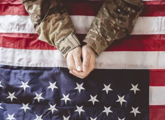a soldier holding the american flag