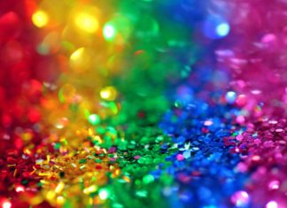 a close up of a rainbow colored glitter