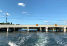 a bridge over a body of water with power lines above it