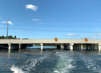 a bridge over a body of water with power lines above it