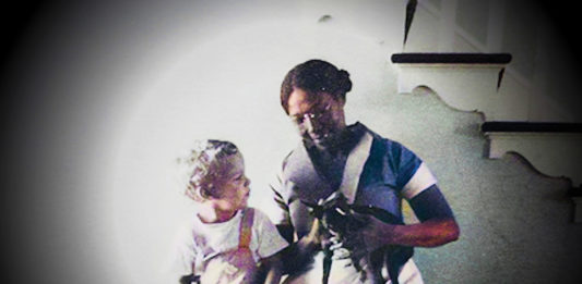 a man and a little girl standing next to each other