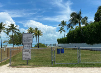 a fenced in area with a sign on it