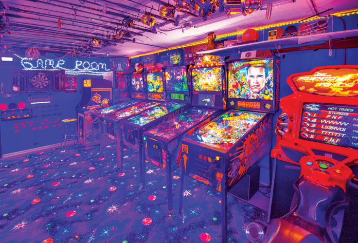 a room filled with arcade machines and neon lights