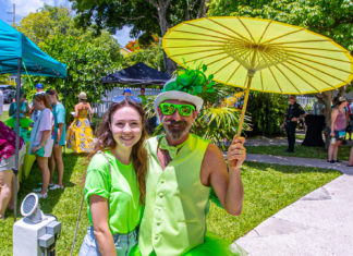 a man and woman dressed in green pose for a picture