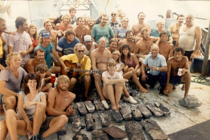 a group of men and women posing for a picture