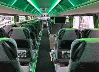 the inside of a bus with green lights