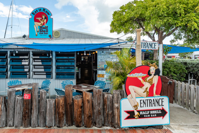 the entrance to a restaurant with a blue awning