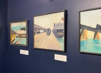 a row of paintings hanging on a wall