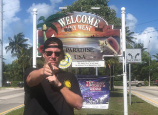 a man standing in front of a welcome sign