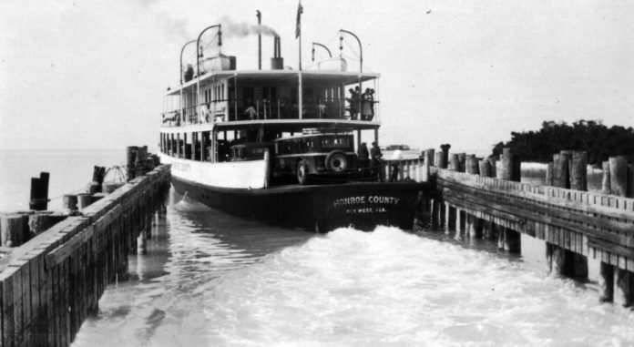 a large boat traveling down a river next to a pier