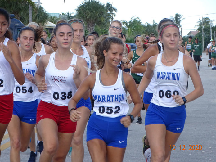 a group of girls running in a marathon