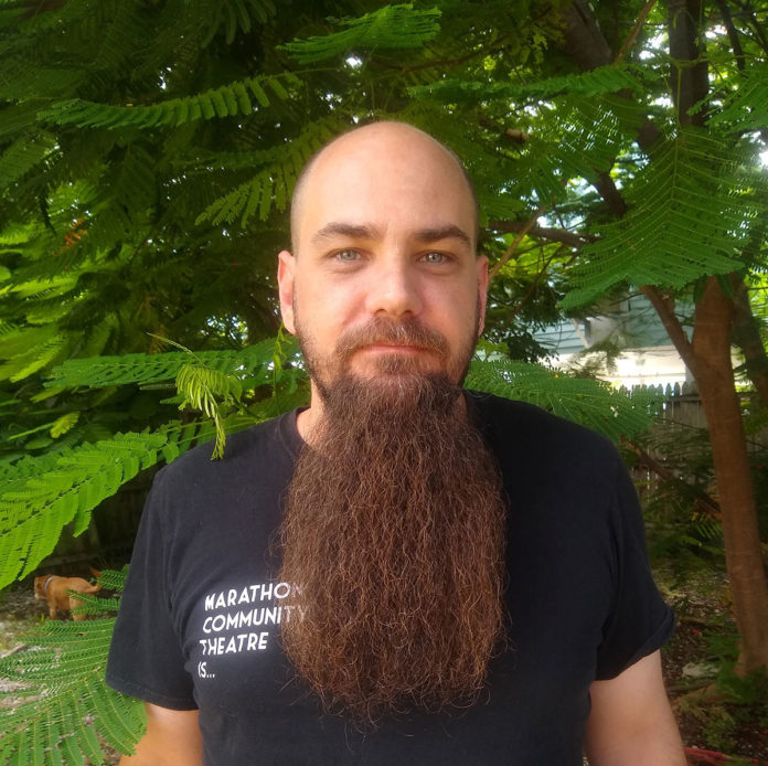 a man with a long beard wearing a black shirt