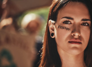 a woman with a word painted on her face