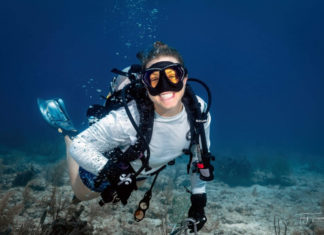 a man wearing a diving mask and diving in the ocean