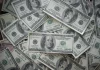 a pile of twenty dollar bills sitting on top of each other