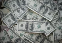 a pile of twenty dollar bills sitting on top of each other