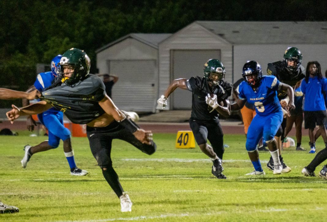 IN PICTURES ’CANES VARSITY FOOTBALL CLOBBERS PALM GLADES