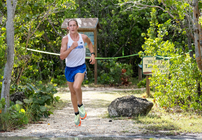 a man running on a trail in the woods